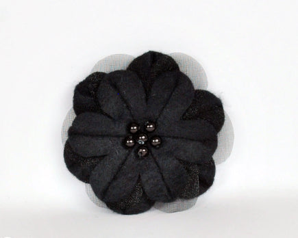 Black soft felt flower brooch with sheer inset petals and pearl beads at the centre. 
