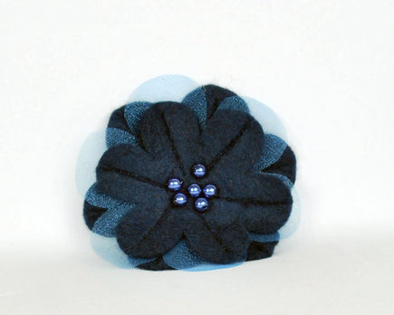 Navy soft felt flower brooch with sheer inset petals and pearl beads at the centre. 